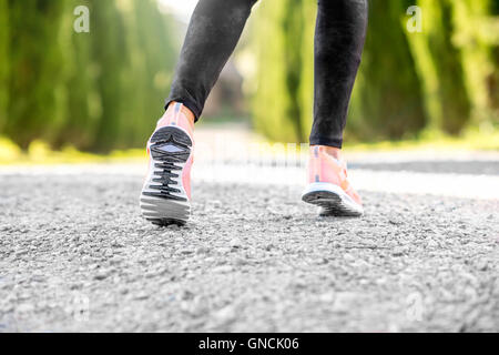 Female legs in sport sneakers Stock Photo