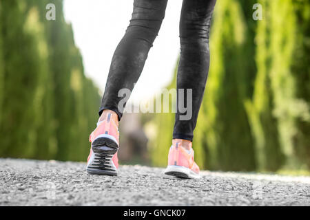 Female legs in sport sneakers Stock Photo