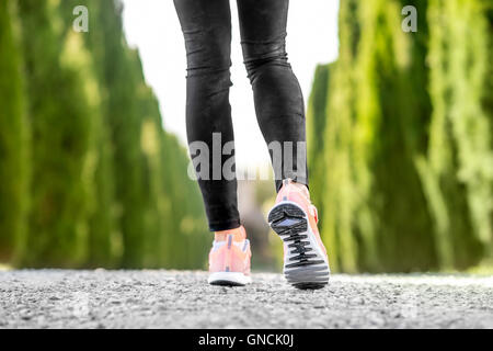 Female legs in sport sneakers Stock Photo