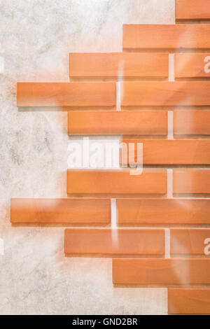 Red bricks pattern on polished cement wall. Stock Photo