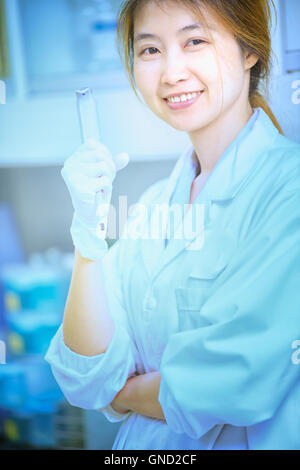 Portrait of happy young science woman standing Stock Photo