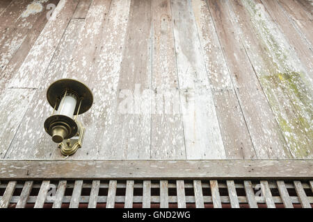 The old style lantern hang on old wooden wall. Stock Photo