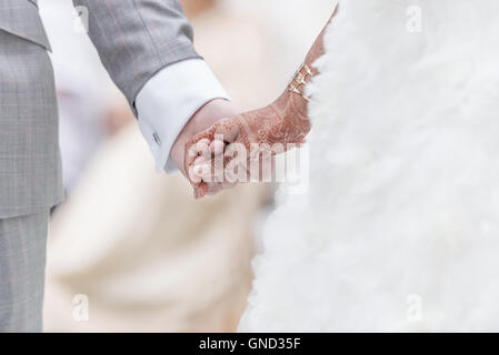 Close-up Holding Hands in indian wedding ritual. Stock Photo