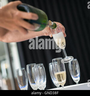 Man pouring champagne into glass, selective focus. Stock Photo