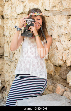 Girl with vintage camera on a old town street Stock Photo