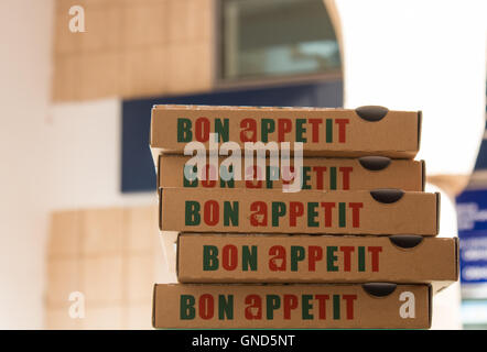 Pile of boxes of pizza, ready to be filled with fresh and tasty pizza and being delivered to the clients. Stock Photo