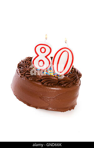 Isolaed on white chocolate frosted cake with various numbered candles on top. Stock Photo