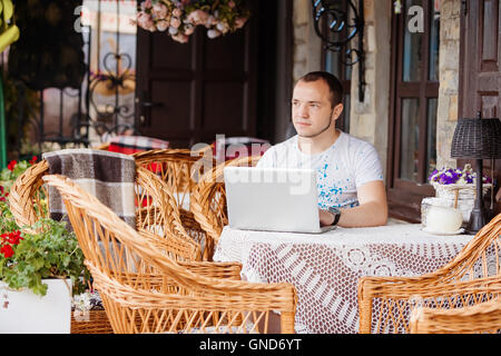 man in caffee works on his laptop Stock Photo