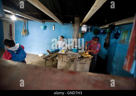 Maya indigenous family in the kitchen at home in Caserio Panuca in Solola department Guatemala. Stock Photo