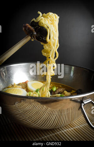 Korean cuisine ramen noodle soup with mushrooms and hard boiled eggs Stock Photo