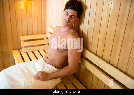Handsome young man relaxing in the sauna Stock Photo