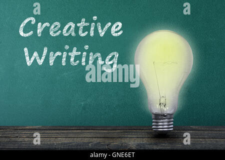 Creative Writing text on green board and light bulb on table Stock Photo