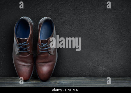 Black board and business shoes on wooden floor Stock Photo