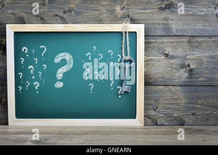 Questions text on school board and old key Stock Photo