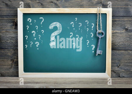 Questions text on school board and old key Stock Photo