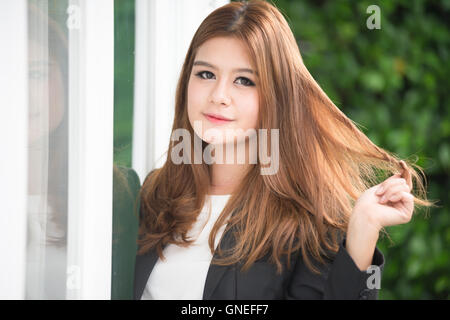 asia confident young businesswoman in suit holding hands on hair Stock Photo