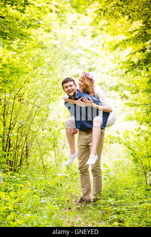 Beautiful wedding couple outside in green forest. Stock Photo