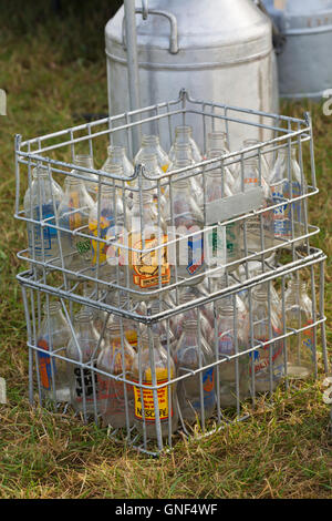 empty glass milk bottles and milk churns at Great Dorset Steam Fair, Tarrant Hinton, Dorset UK in August Stock Photo