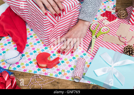 wrapping Christmas gift and presents for whole family Stock Photo - Alamy