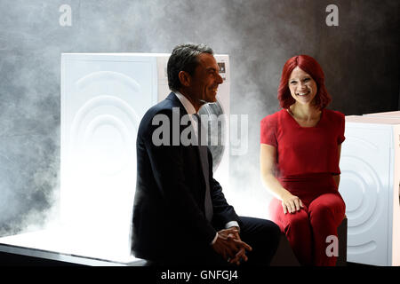 Roland Hagenbucher, CEO of Siemens in the field of household appliances, and Miss Ifa sit in front of a washine machine that uses active oxygen to get rid smells in clothing at the stall of German engineering company Siemens on the first press day in the run-up to the international radio exhibition (IFA) in Berlin, Germany, 31 August 2016. The IFA is considered the worldwide biggest leading fair for entertainment electronics, IT and household appliances. It will take place on 2-7 September 2016 on the Berlin fair grounds. PHOTO: RAINER JENSEN/dpa Stock Photo