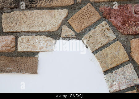 Wall of a building with decoration made of colorful bricks. From beige, orange to red color. Stock Photo