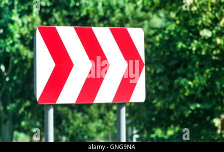 Red and white road sign on right at sunny day Stock Photo