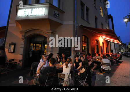 'Guests sit in front of the restaurant ''Hey Luigi'' in Munich, 2014' Stock Photo
