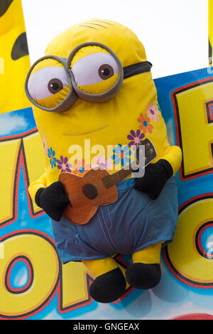 Minions soft cuddly toy playing guitar on fairground stall Stock Photo