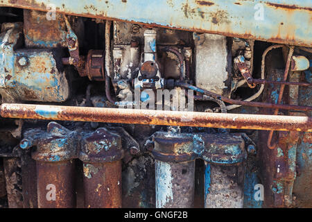 Old rusted steel details, farm tractor engine fragment Stock Photo