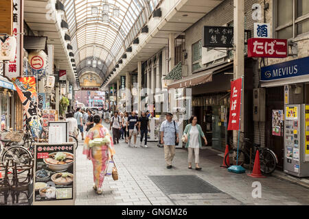 People walk down the Shin Nakamise shopping arcade in Asakusa, Tokyo, Japan. Stock Photo