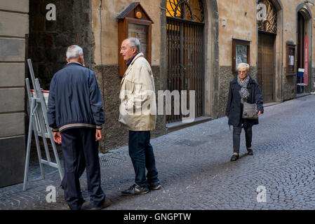 Senior people talking on street, Orvieto, Terni Province, Umbria, Italy Stock Photo