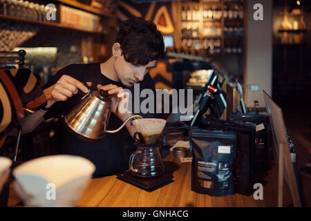 Barista at work in a coffee shop Stock Photo