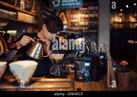 Barista at work in a coffee shop Stock Photo