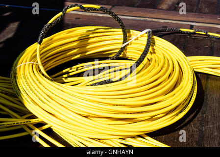 Karlskrona, Sweden - August 27, 2016: Coiled up Interspiro supply hose diving equipment. Hose is bright yellow. For when using s Stock Photo