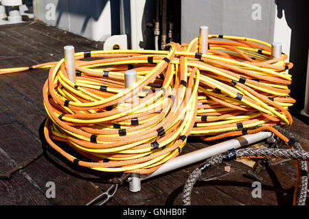 Karlskrona, Sweden - August 27, 2016: Coiled up Interspiro lifeline supply hose diving equipment. Hose is bright yellow and bund Stock Photo