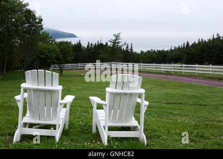 Seats overlook the ocean at the Doctor's House Inn and Spa at Green's Harbour in Newfoundland and Labrador, Canada. Stock Photo
