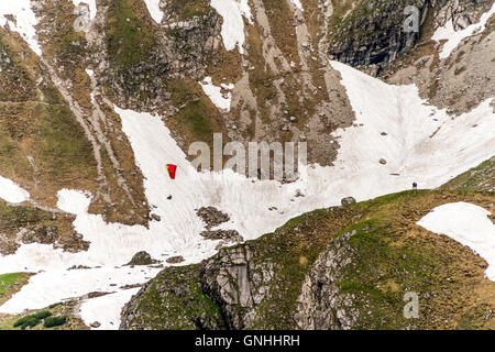 hiker and Paraglider in the Allgäu Alps near Oberstdorf, Oberallgäu, Bavaria, Germany Stock Photo