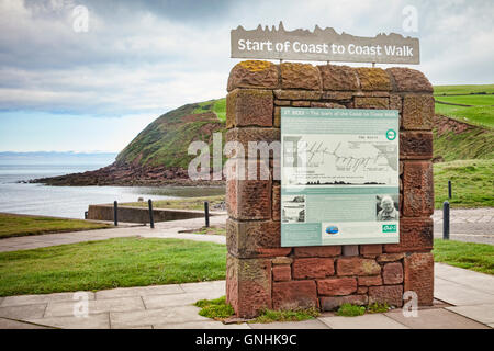 Information board at St Bees, Cumbria, marking the start of Alfred Wainwright's Coast to Coast Walk, which finishes at Robin... Stock Photo