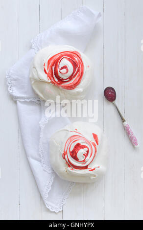 Large strawberry meringues with spoon of jam. Stock Photo