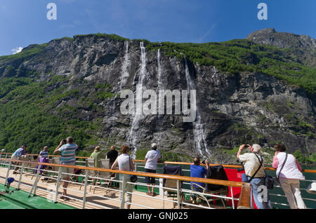 Passengers on the deck of the cruise ship Arcadia taking photographs of the Seven Sisters waterfall, Norway Stock Photo