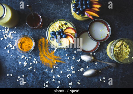 Healthy Golden milk overnight oats for breakfast with fresh fruits {gluten-free) Stock Photo