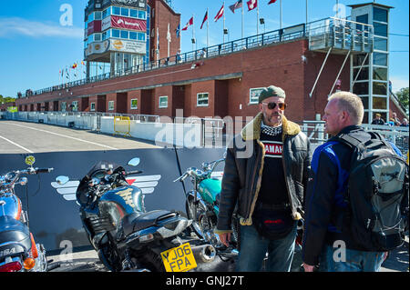 Two bikers talking near Grandstand at the Manx Festival of Motorcyling 2016 Stock Photo
