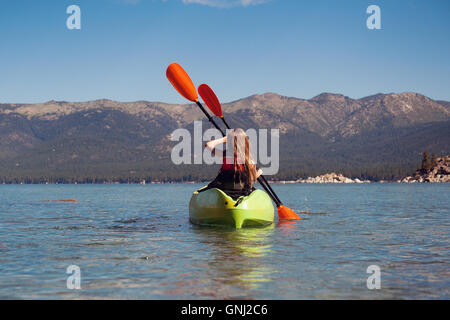 Rear view of girl kayaking with brother, Lake Tahoe, California, United States Stock Photo