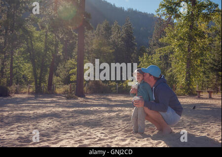 Father and son having a drink in mountains, Lake Tahoe, California, United States Stock Photo