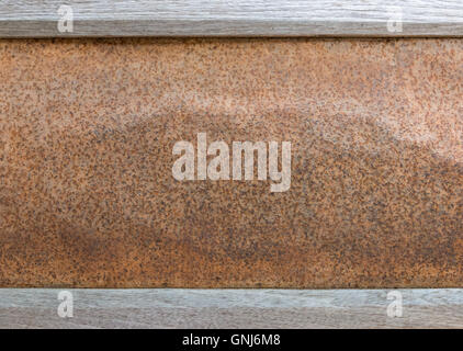 Rusty zinc wall with the wooden frame of the local fence in the countryside of Thailand. Stock Photo