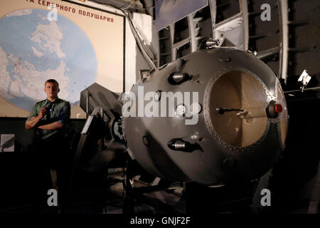 A uniformed Russian guide stands next to the first Soviet atomic bomb 'RDS-1' also known as Izdeliye 501 (device 501) which was the nuclear bomb used in the Soviet Union's first nuclear weapon test  displayed inside the Tagansky Protected Command Point, also known as bunker-42 a once-secret military complex, bunker, and Spare Long-Range Aviation Command Post located 65 meters below the streets of Moscow, the actual formerly secret location where military Soviet leaders could retreat in the event of an atomic attack on Russia. central Moscow Russia Stock Photo