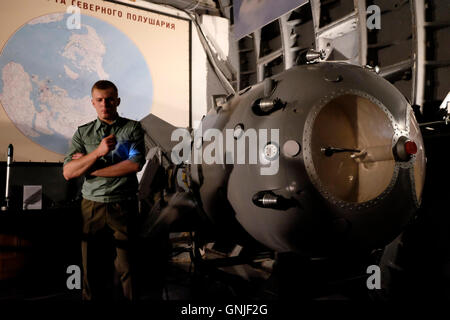 A uniformed Russian guide stands next to the first Soviet atomic bomb 'RDS-1' also known as Izdeliye 501 (device 501) which was the nuclear bomb used in the Soviet Union's first nuclear weapon test  displayed inside the Tagansky Protected Command Point, also known as bunker-42 a once-secret military complex, bunker, and Spare Long-Range Aviation Command Post located 65 meters below the streets of Moscow, the actual formerly secret location where military Soviet leaders could retreat in the event of an atomic attack on Russia. central Moscow Russia Stock Photo