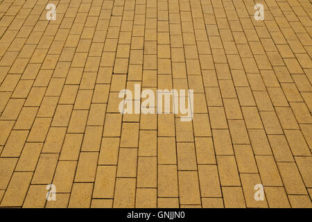 Sidewalk, paved with yellow tiles. Beautiful background Stock Photo