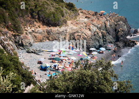 LIGURIA, ITALY - JULY 2016: A small beach in the Liguria area in Italy with mountains in the back Stock Photo