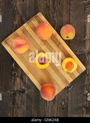 Fresh peaches on wooden table Stock Photo